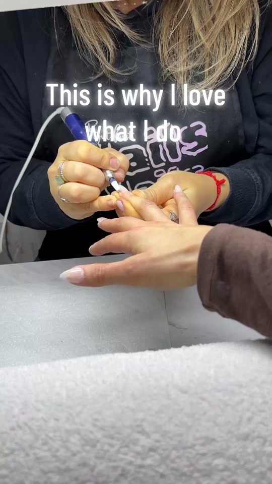Heidi at her station, working on a client's nails