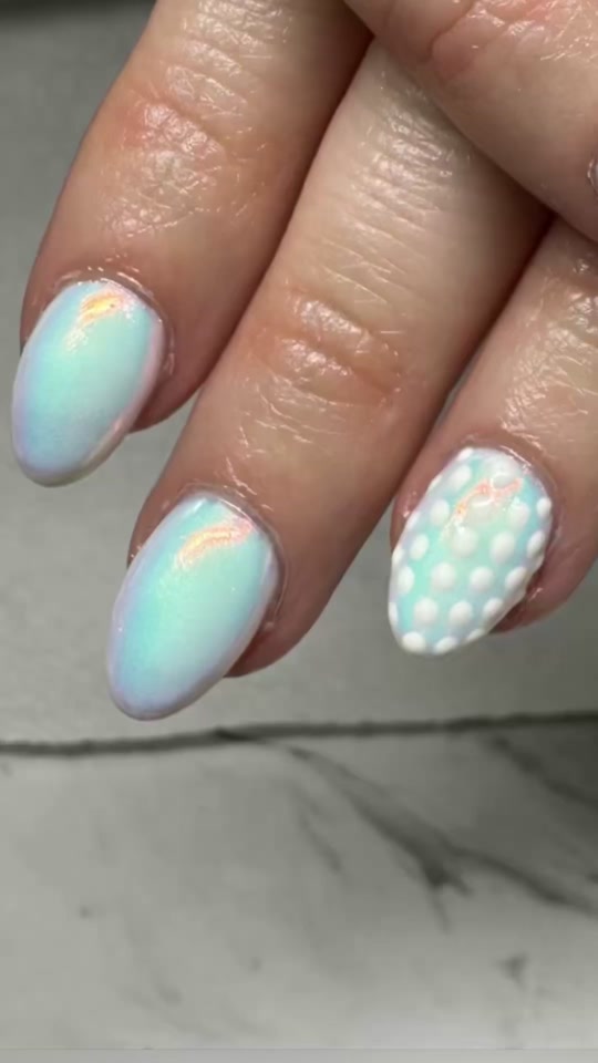 Aqua chrome nails with a white polka-dot accent nail