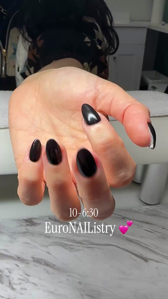 Glossy black almond Gel-X with chrome cat-eye accent nail