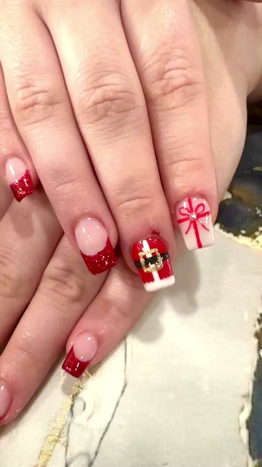 Red French tips with a hand-painted Santa belt accent nail