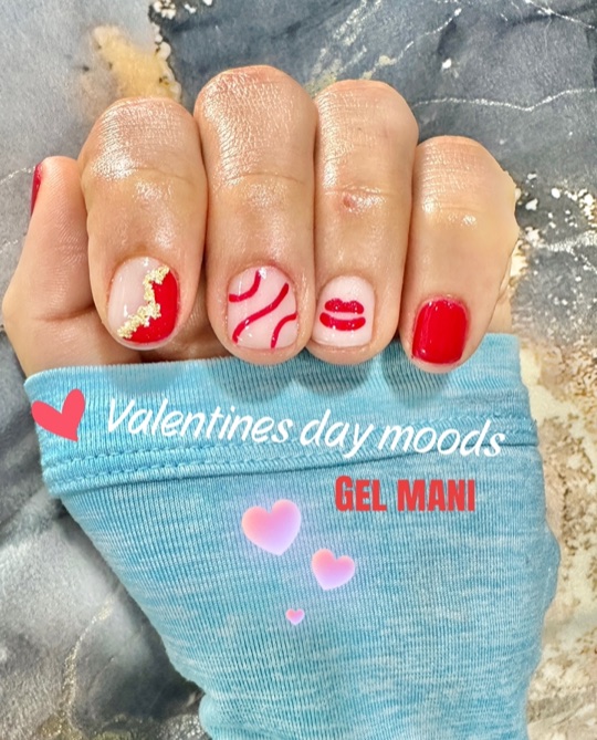Red heart nail art with gold foil accents